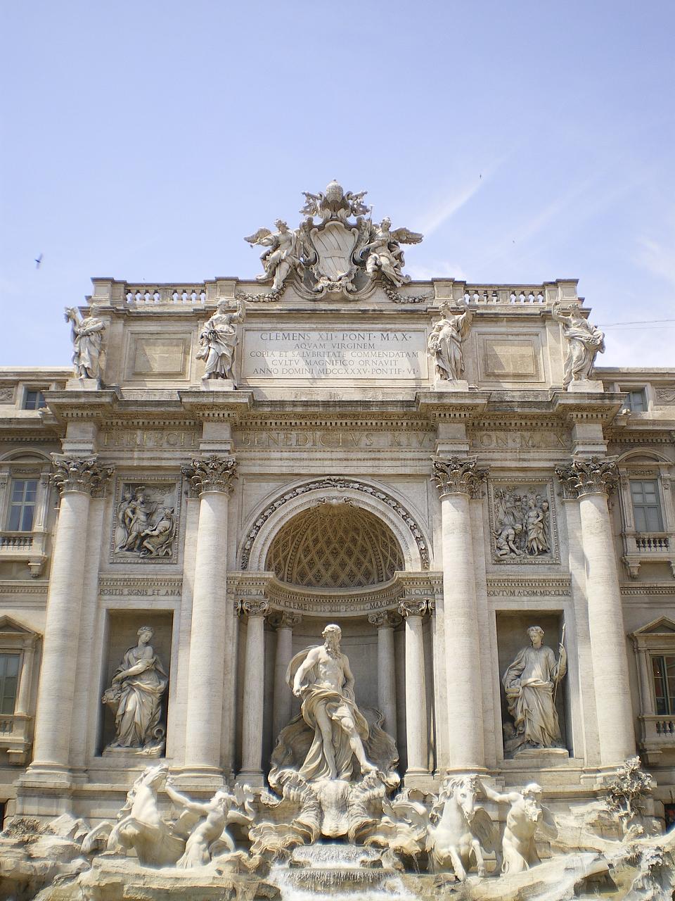 an ornate monument sits outside a large building