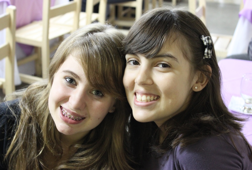 two young women, both smiling at the camera