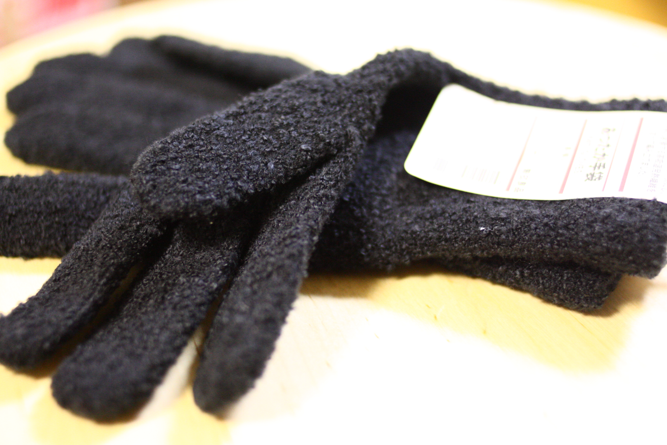 a close up of a black pair of gloves
