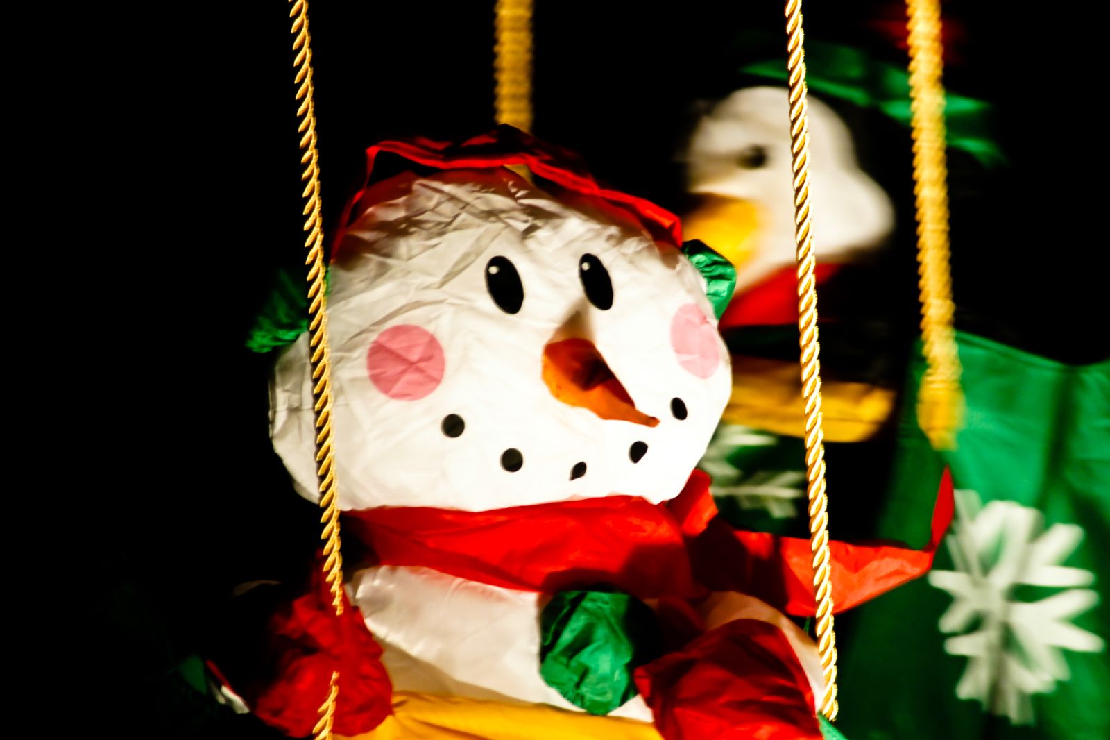 a merry go round with snowmen on top
