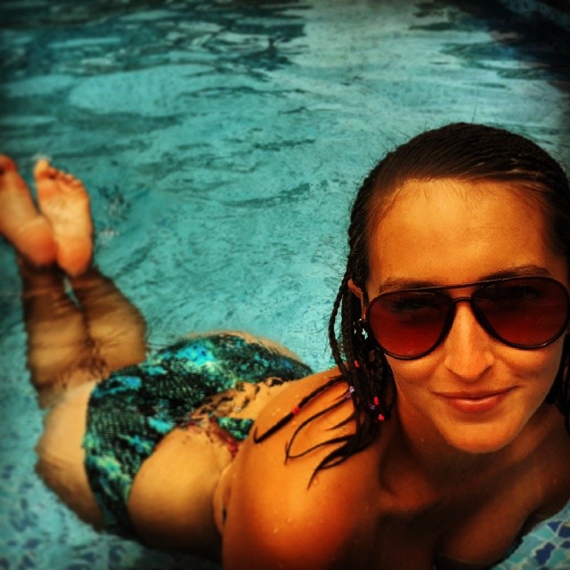 a woman in sunglasses is floating in the water