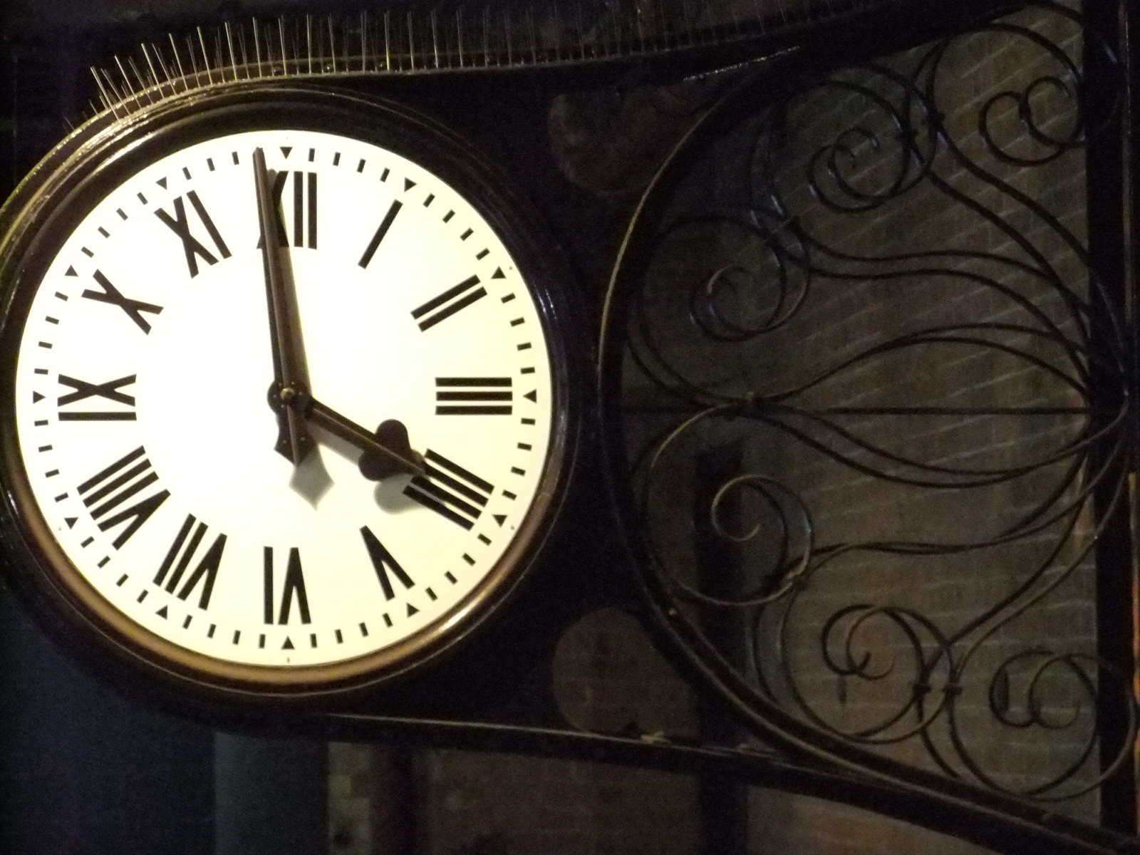 a clock hanging off the side of a building