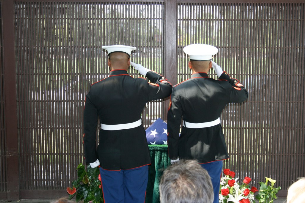 two soldiers are placing flags on top of a table