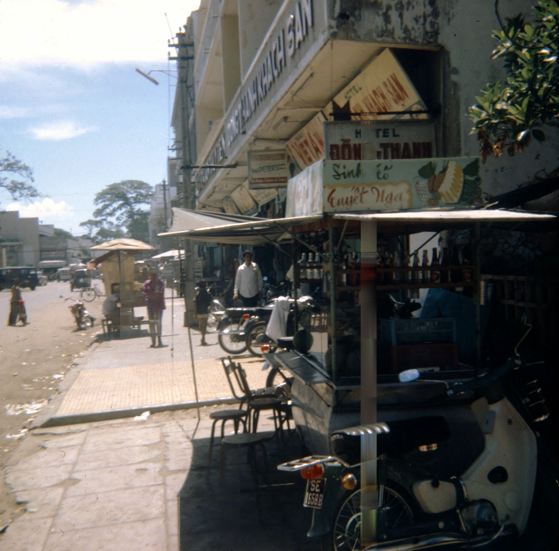 an image of shops with carts and people in the street