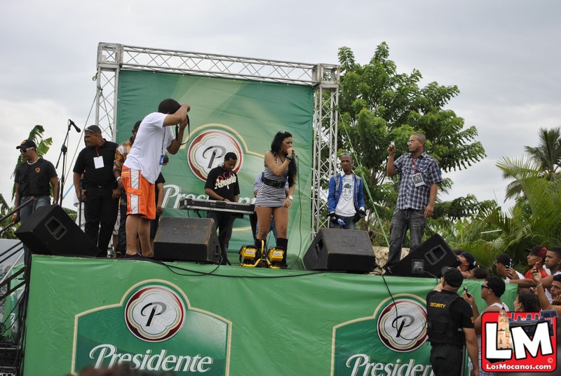 several people standing on stage with a green banner