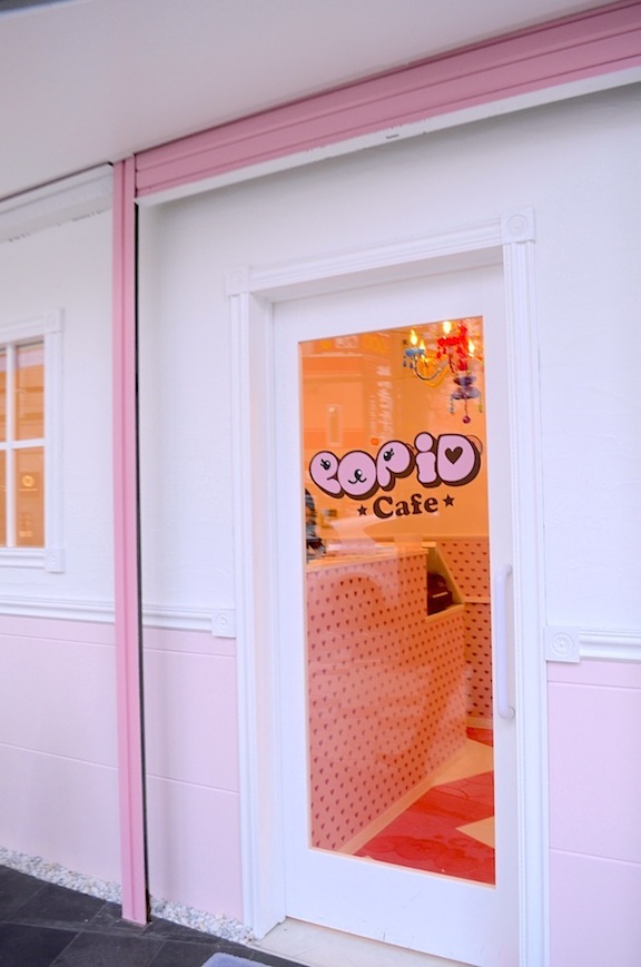 a closed shop front with pink paint on it