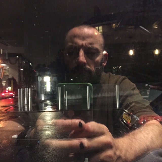 man looking into the window from a restaurant