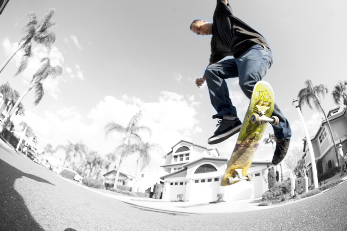 a young man skateboarding in an empty neighborhood