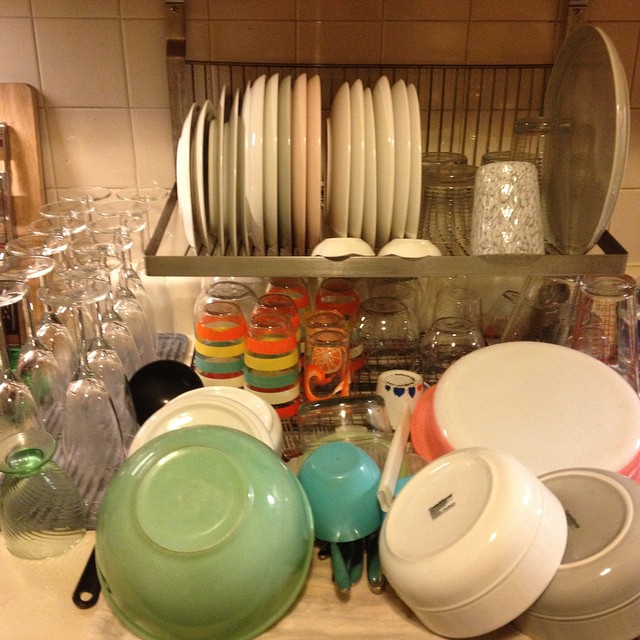 a lot of dishes on a counter top with cups