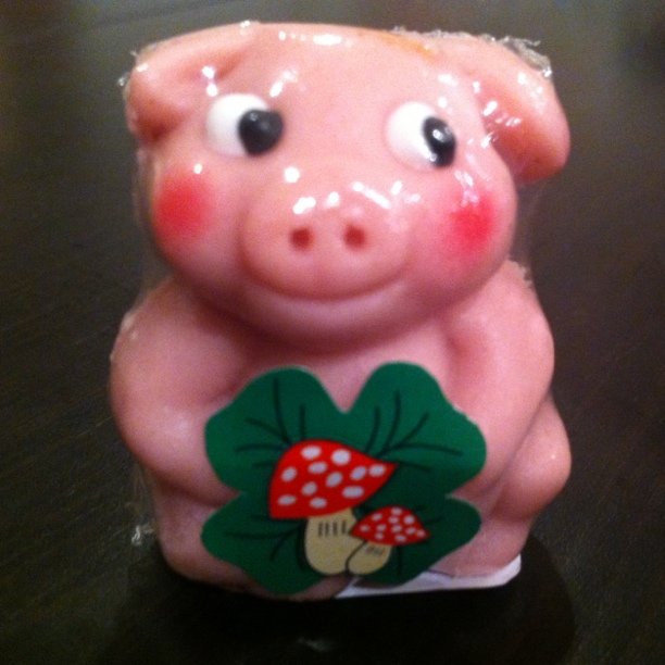 a figurine of a little pig on a table