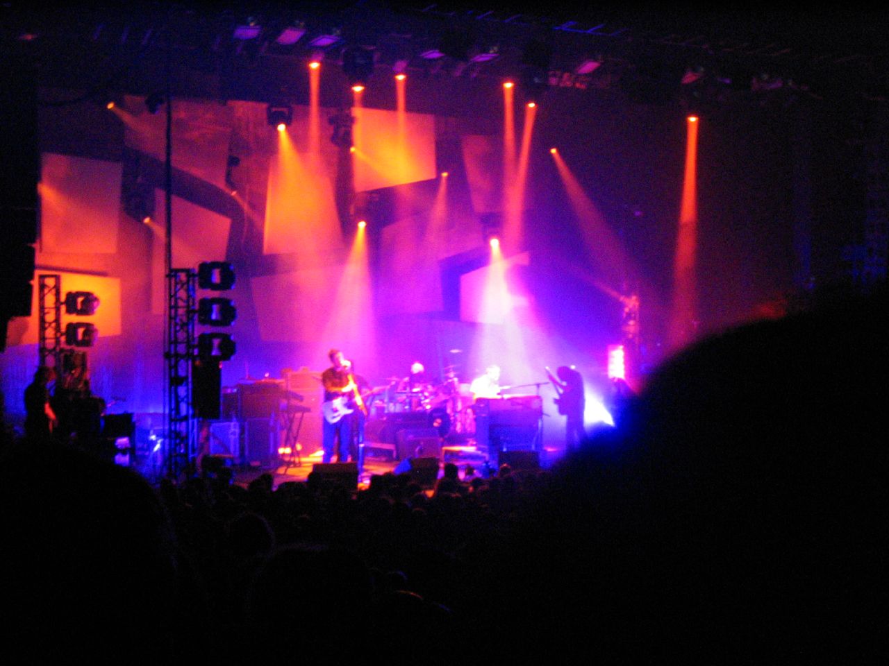 the band in front of an audience at a concert