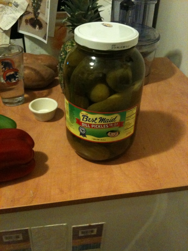 the pickles are next to the jars of pickles