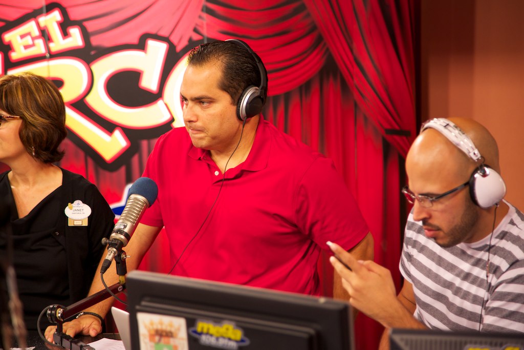 three people talking to each other while holding microphones