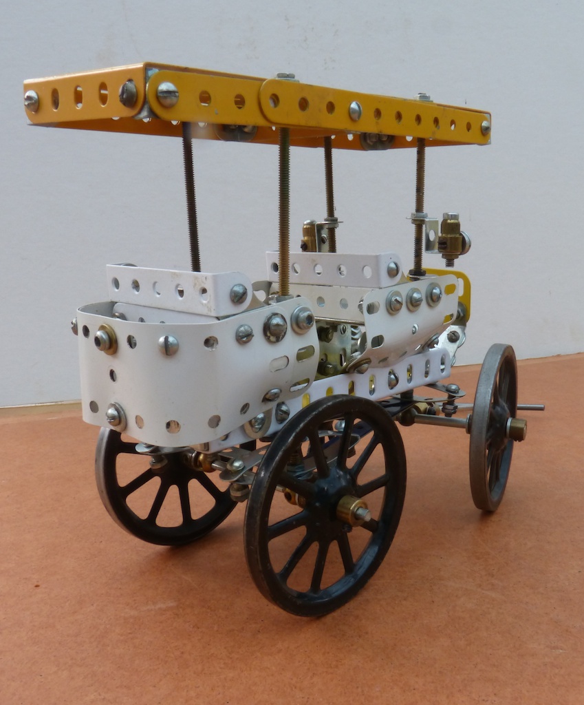 an old fashioned toy wagon with gears on wheels