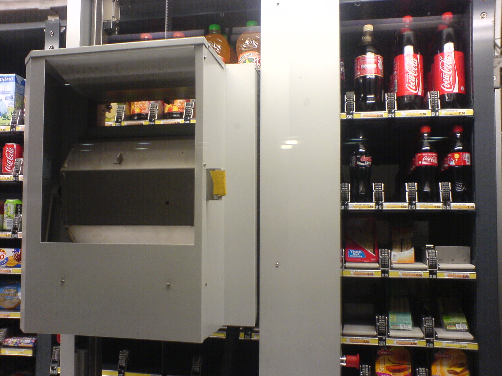 there is a white fridge in a supermarket