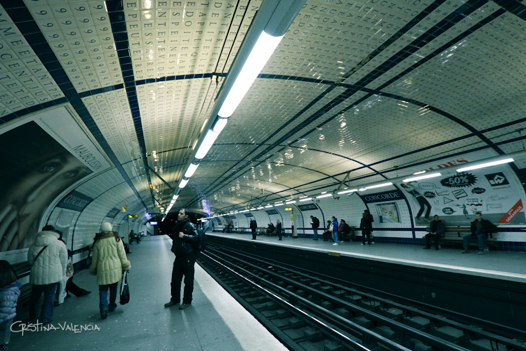 a group of people are standing on the train platform