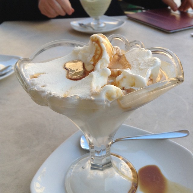 a dessert in a glass with bananas on top of it