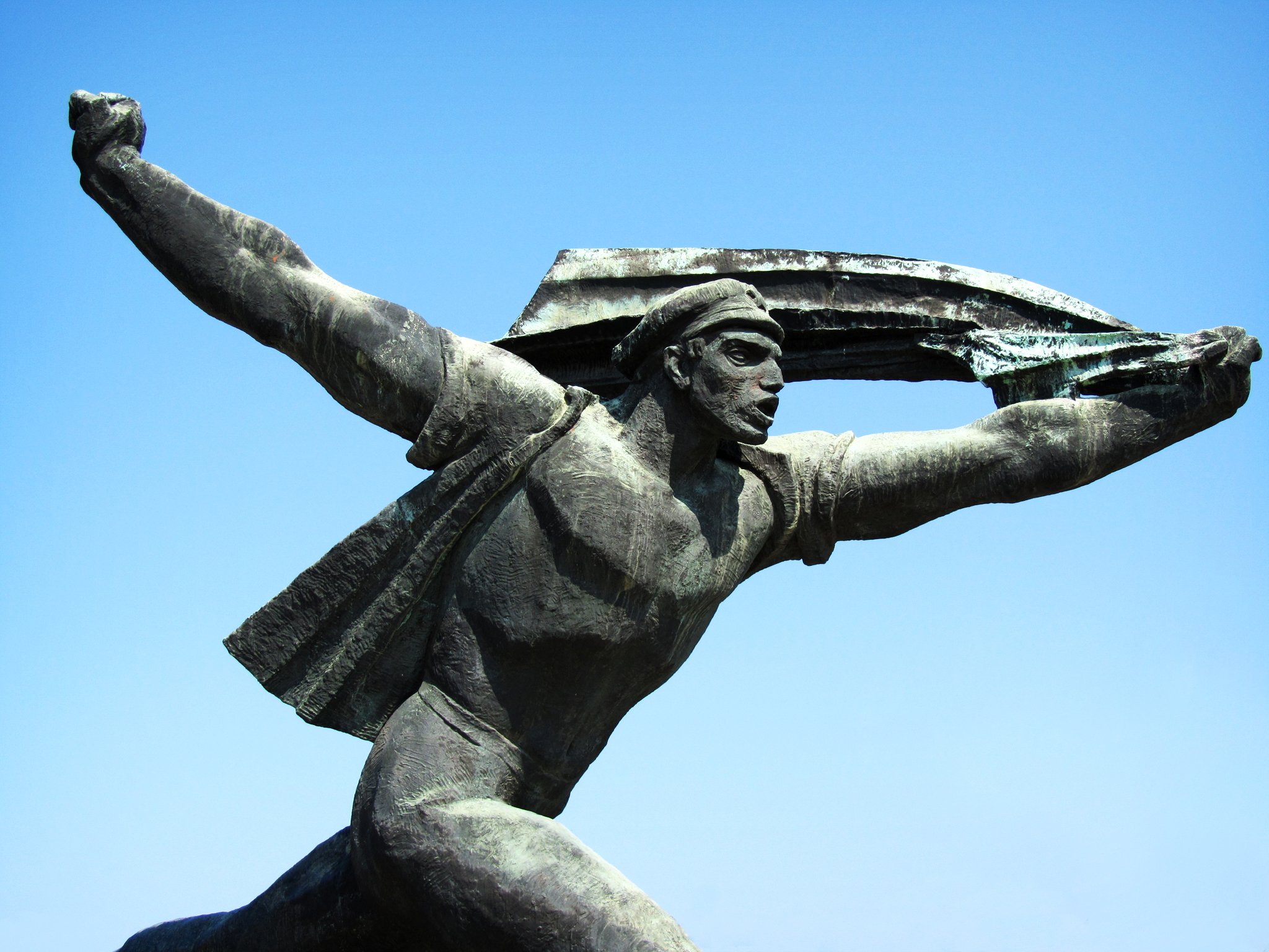 a statue of a female baseball player swinging her glove