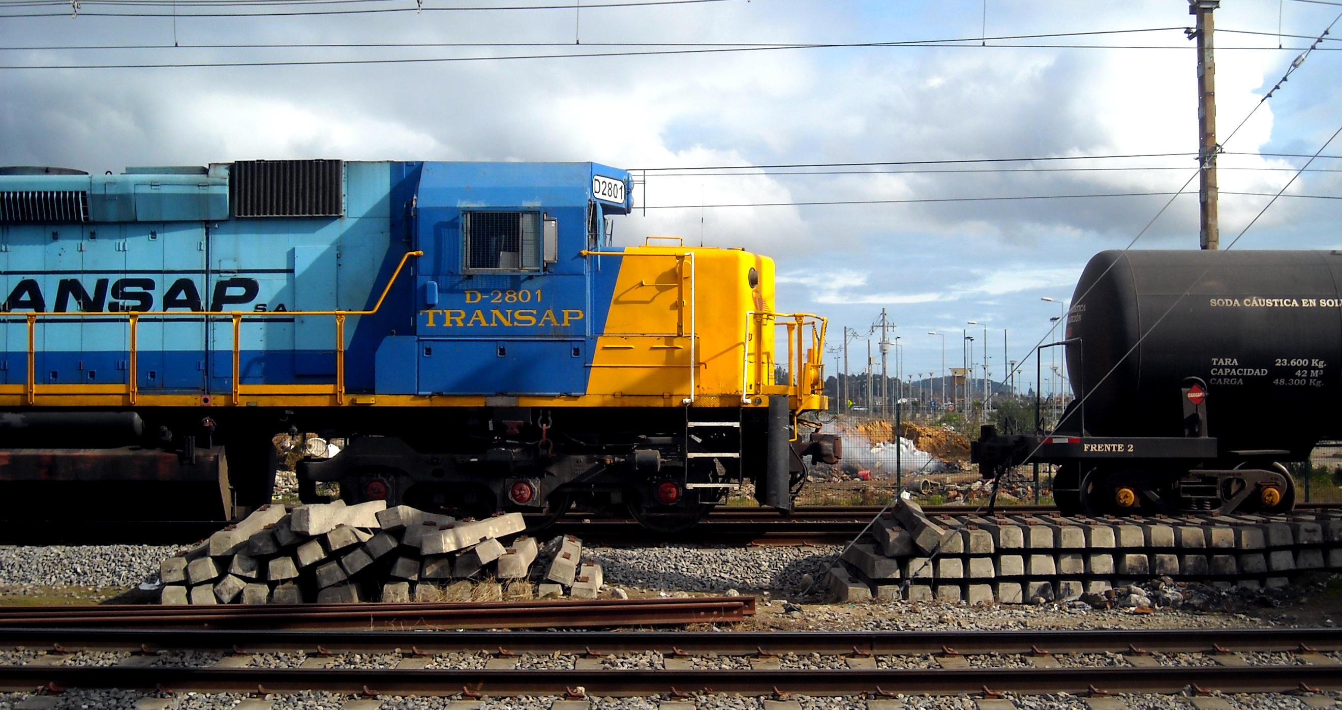 a large train sitting on top of a track next to power poles