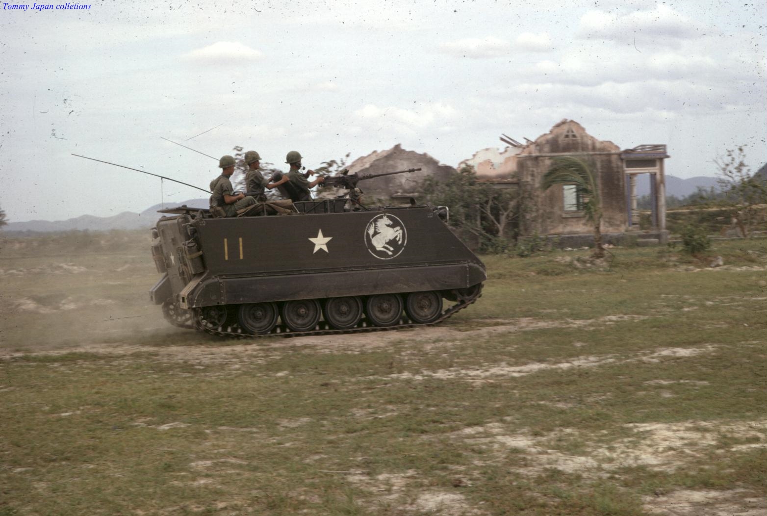 two soldiers on top of an armored vehicle