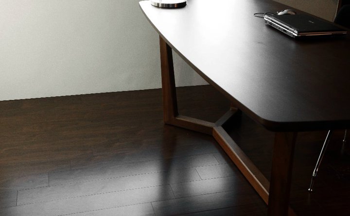 a wooden desk that is on top of a hard wood floor