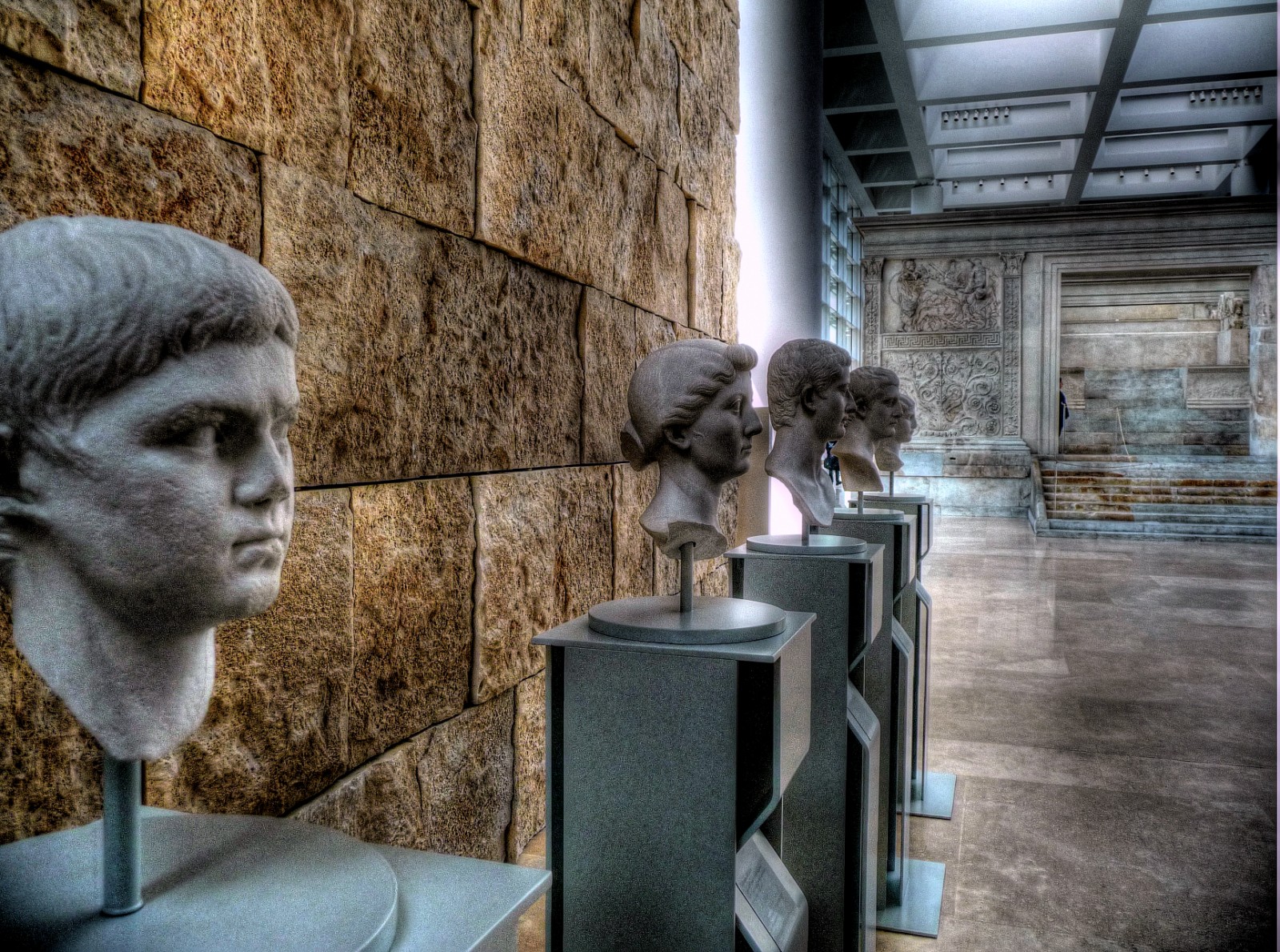 a statue of a woman looking through some shelves