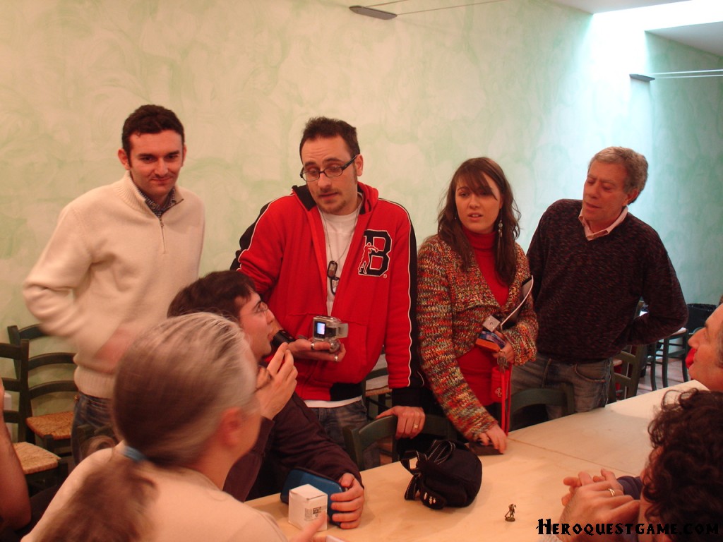 group of people gathered around a long table with camera equipment in hand