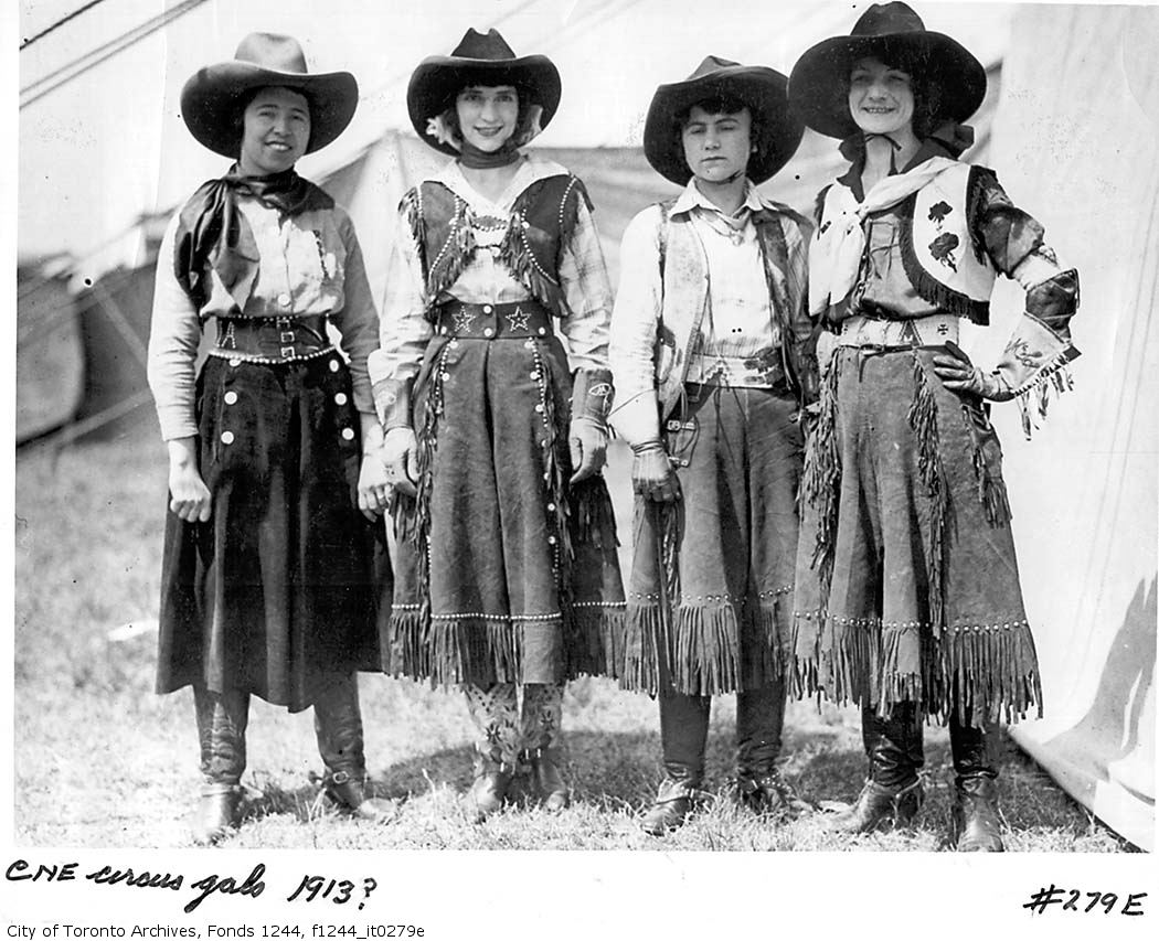 three s in western clothing standing next to each other