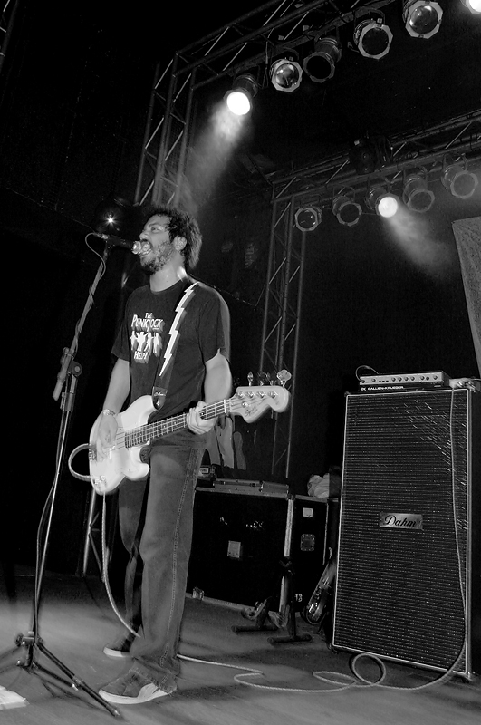 a man is standing on a stage with an electric guitar