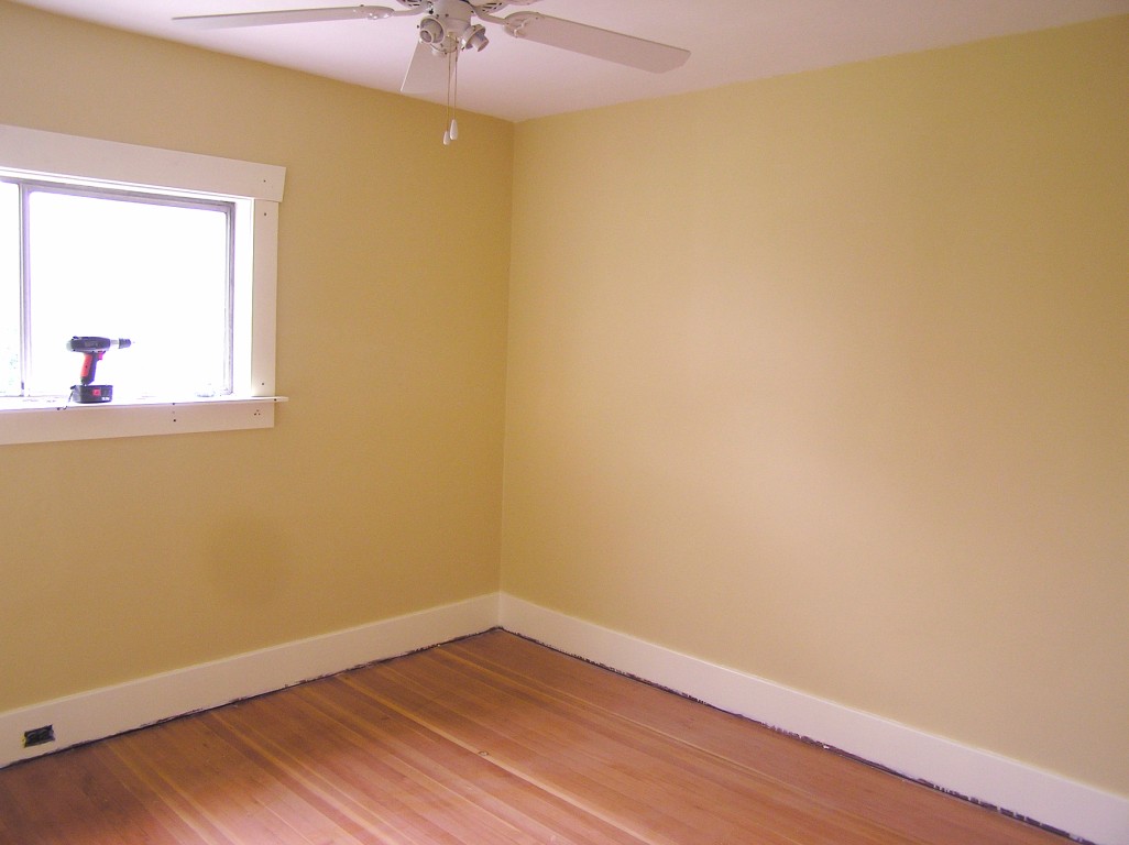 empty room with hard wood floors and yellow wall