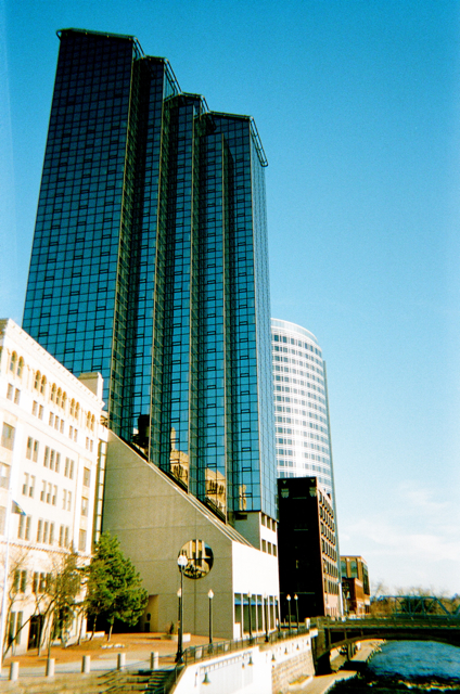 a river flowing past a tall glass building