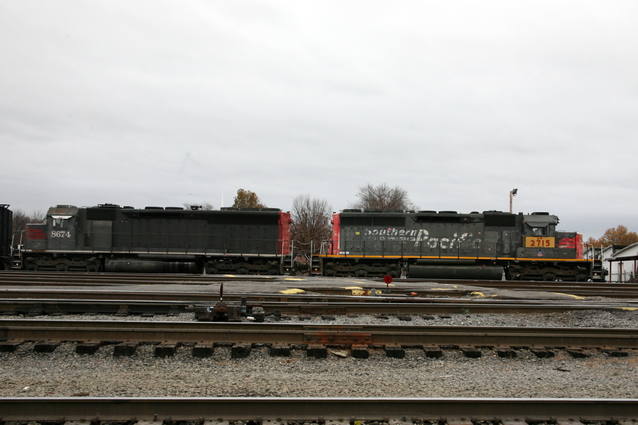 an abandoned train yard and railroad cars are seen