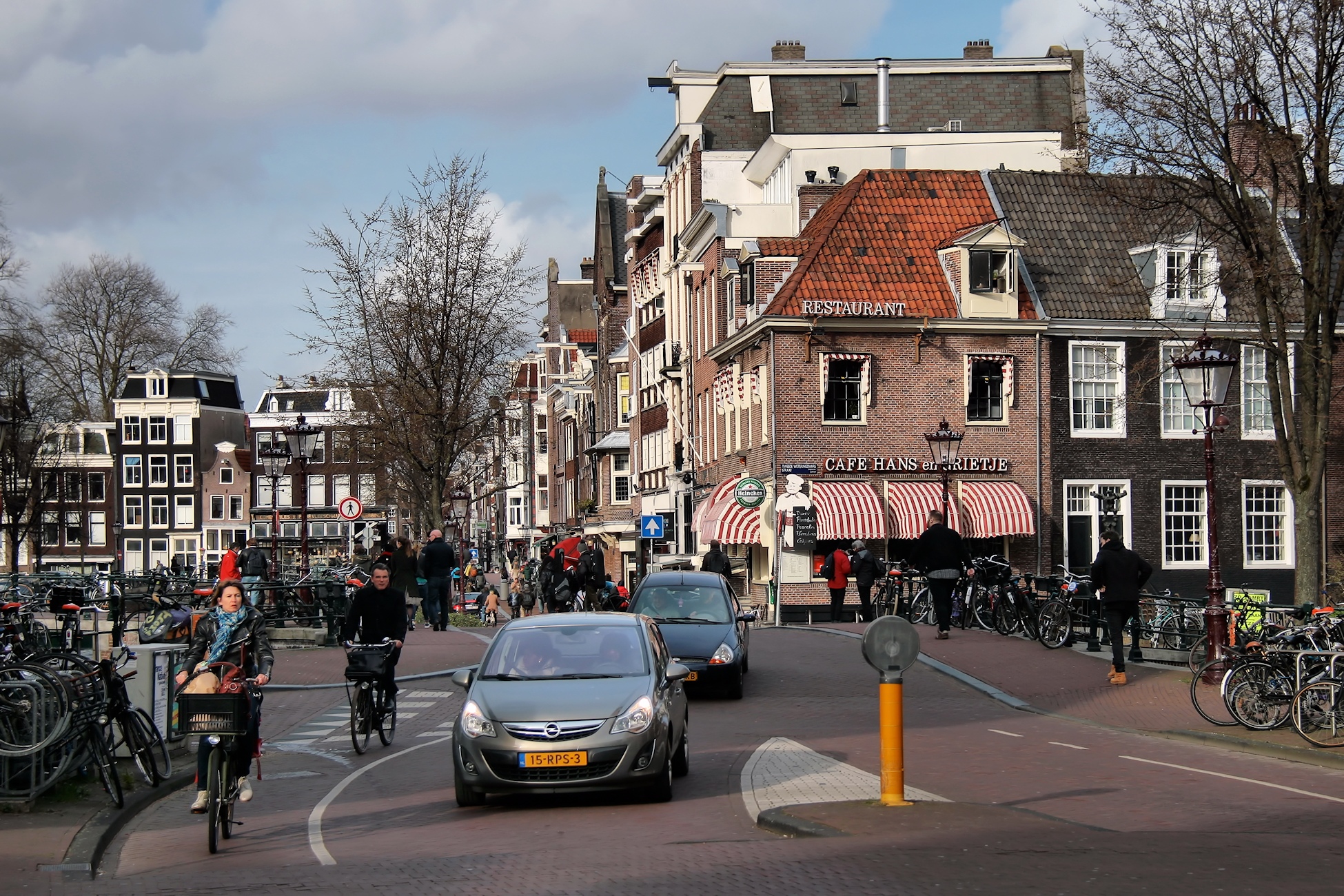 bicycle riders are riding down the road in town