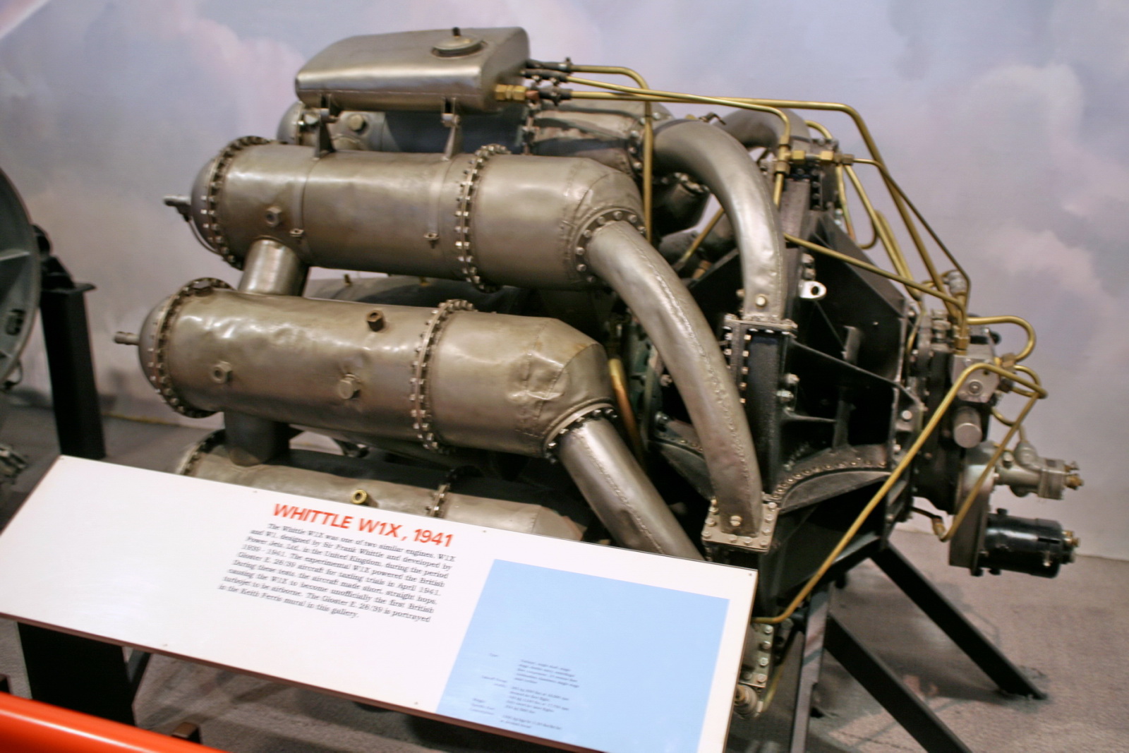 an engine with multiple parts on display on the ground