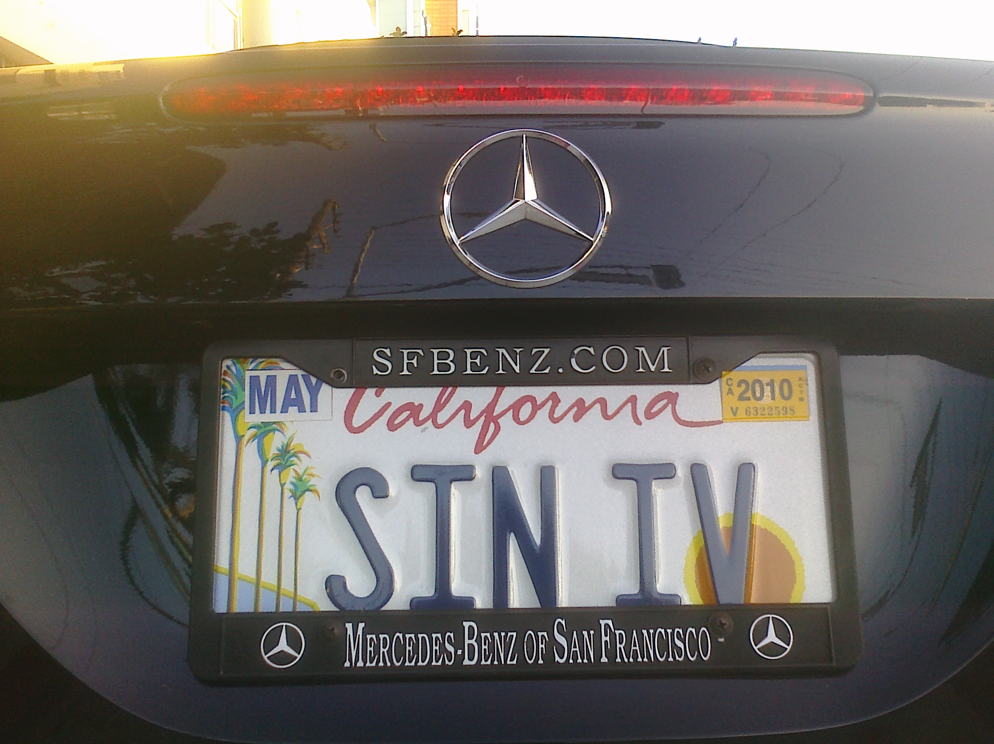 a black mercedes car with a license plate