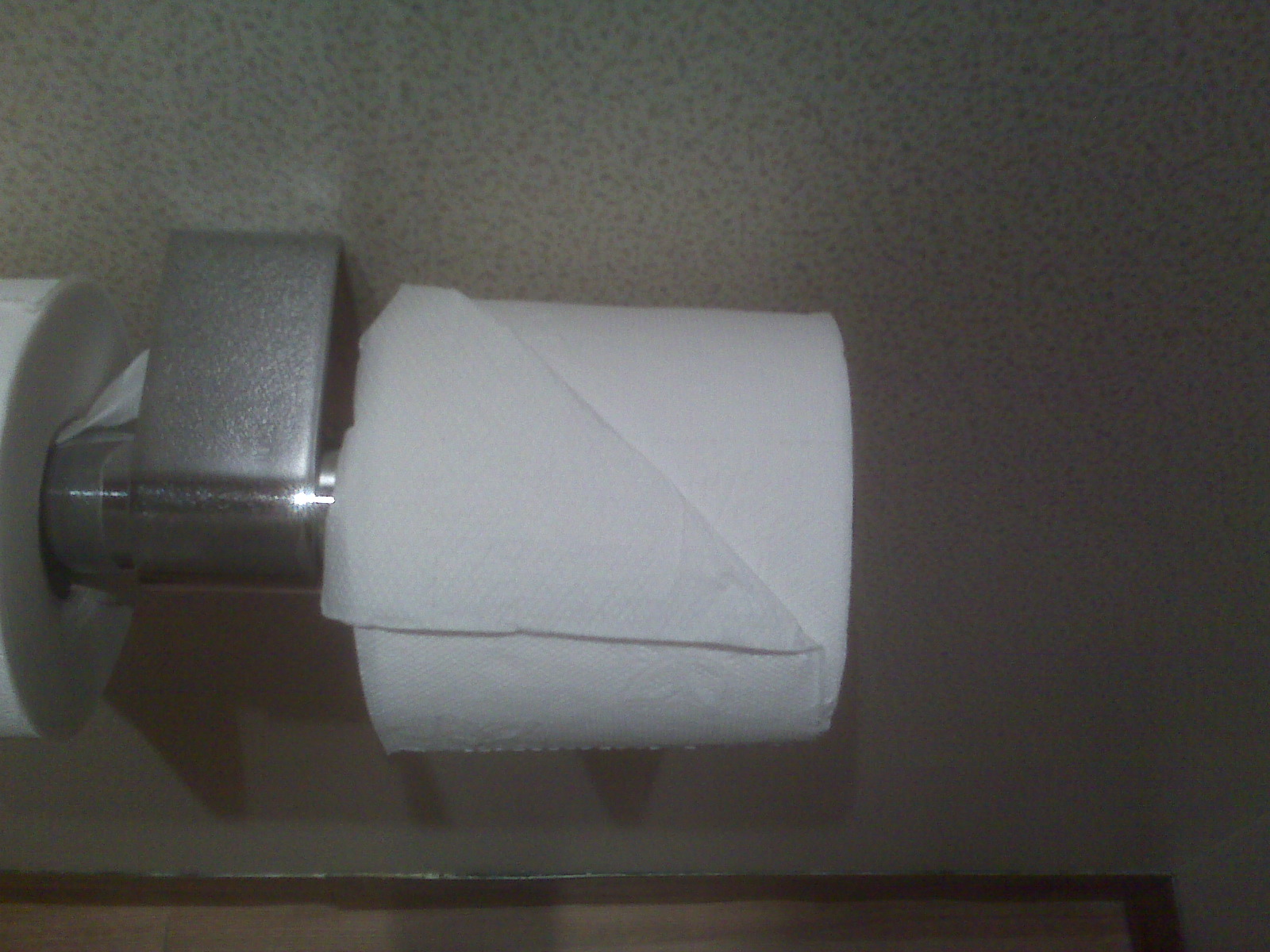 a rolled up white tissue paper in a bathroom
