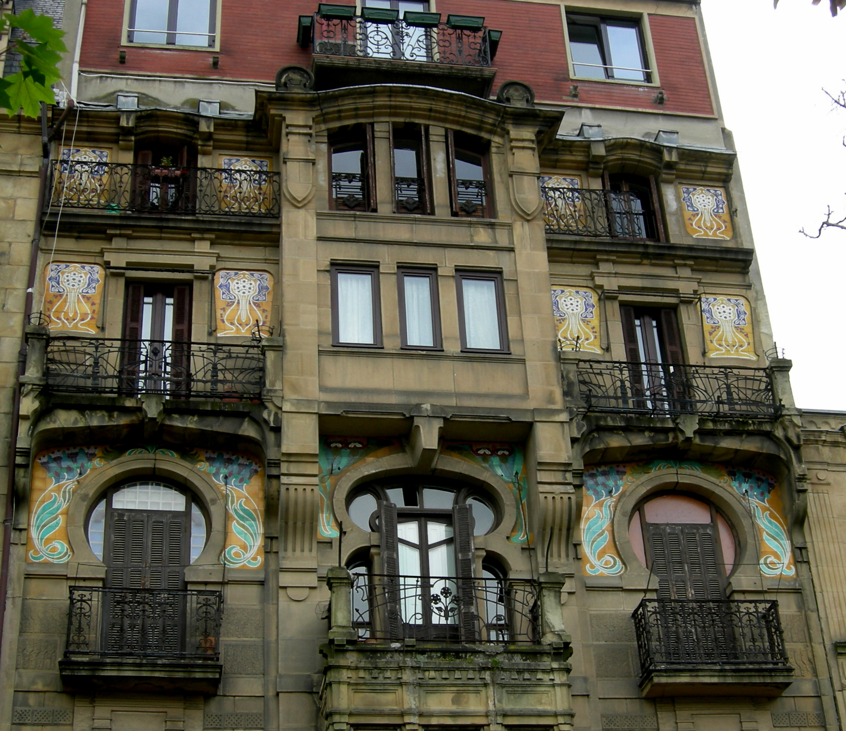 an ornate building with multiple windows and balcony