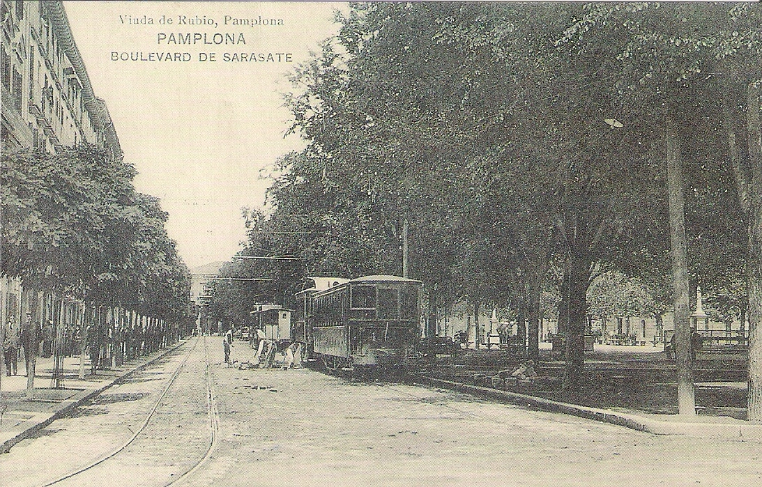 an old picture of the street cars and people in the street