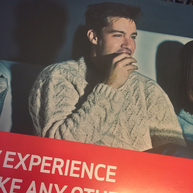 a young man looking out the window at someone