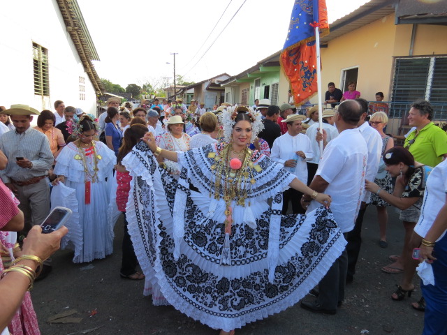 people are in a parade holding large objects