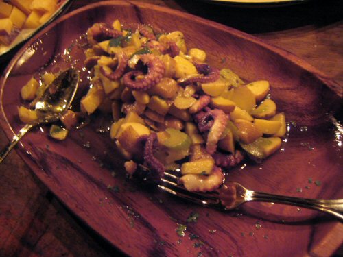 an octo dinner is served with potatoes and other desserts