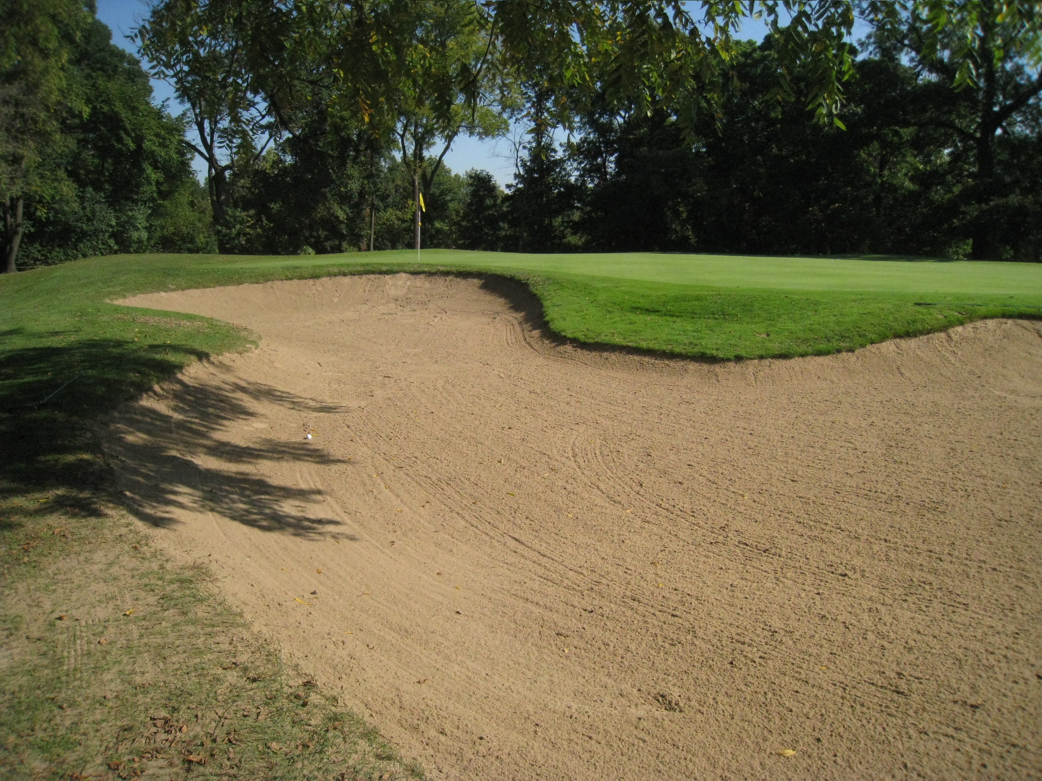 a sand mound in the middle of an empty golf course