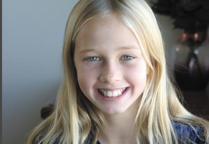 a smiling blonde girl with long blond hair