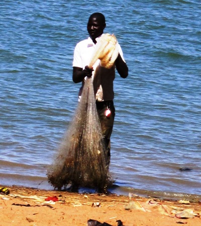 a couple of people standing near a body of water