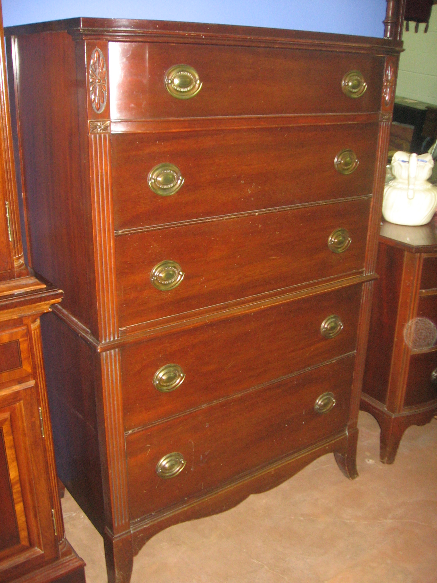 two brown chests a dresser and a brown carpet