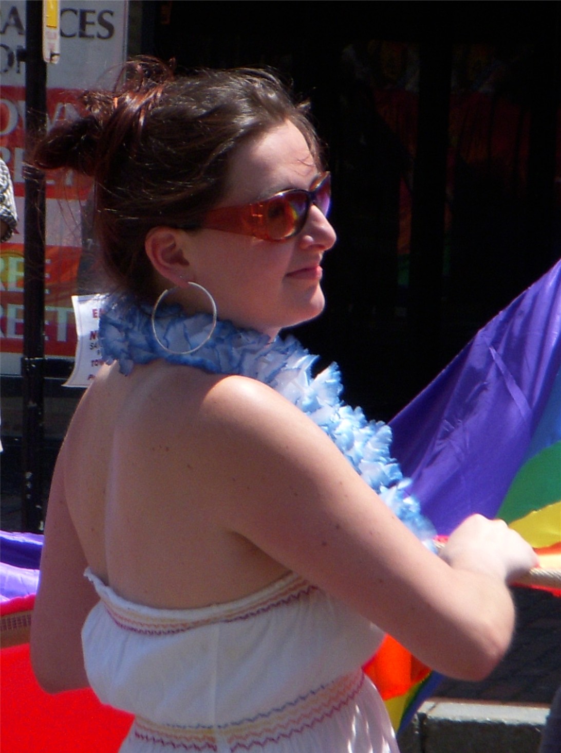 a woman holding onto a multicolored kite