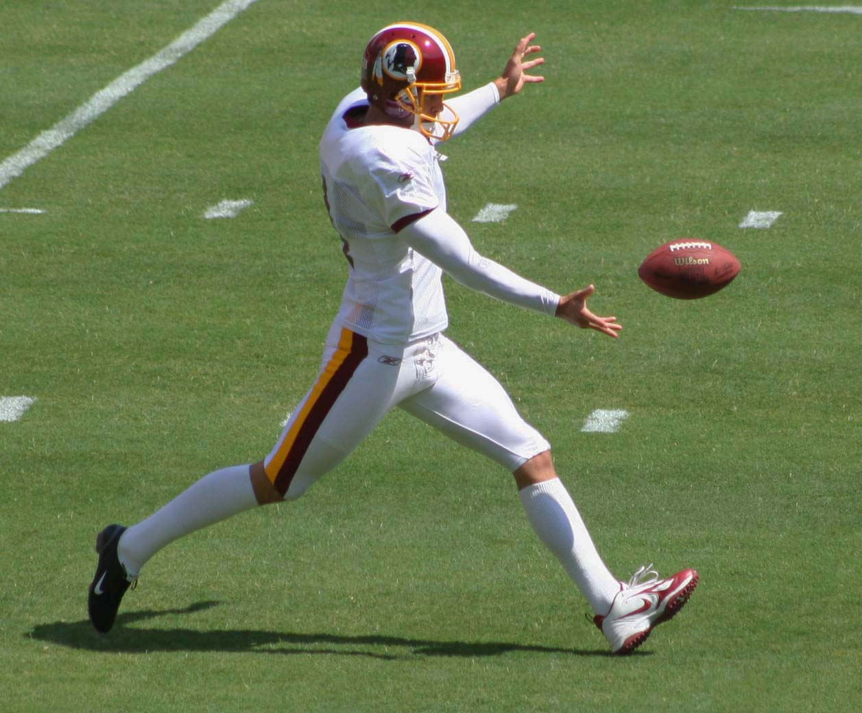 a man wearing a football uniform prepares to catch the ball