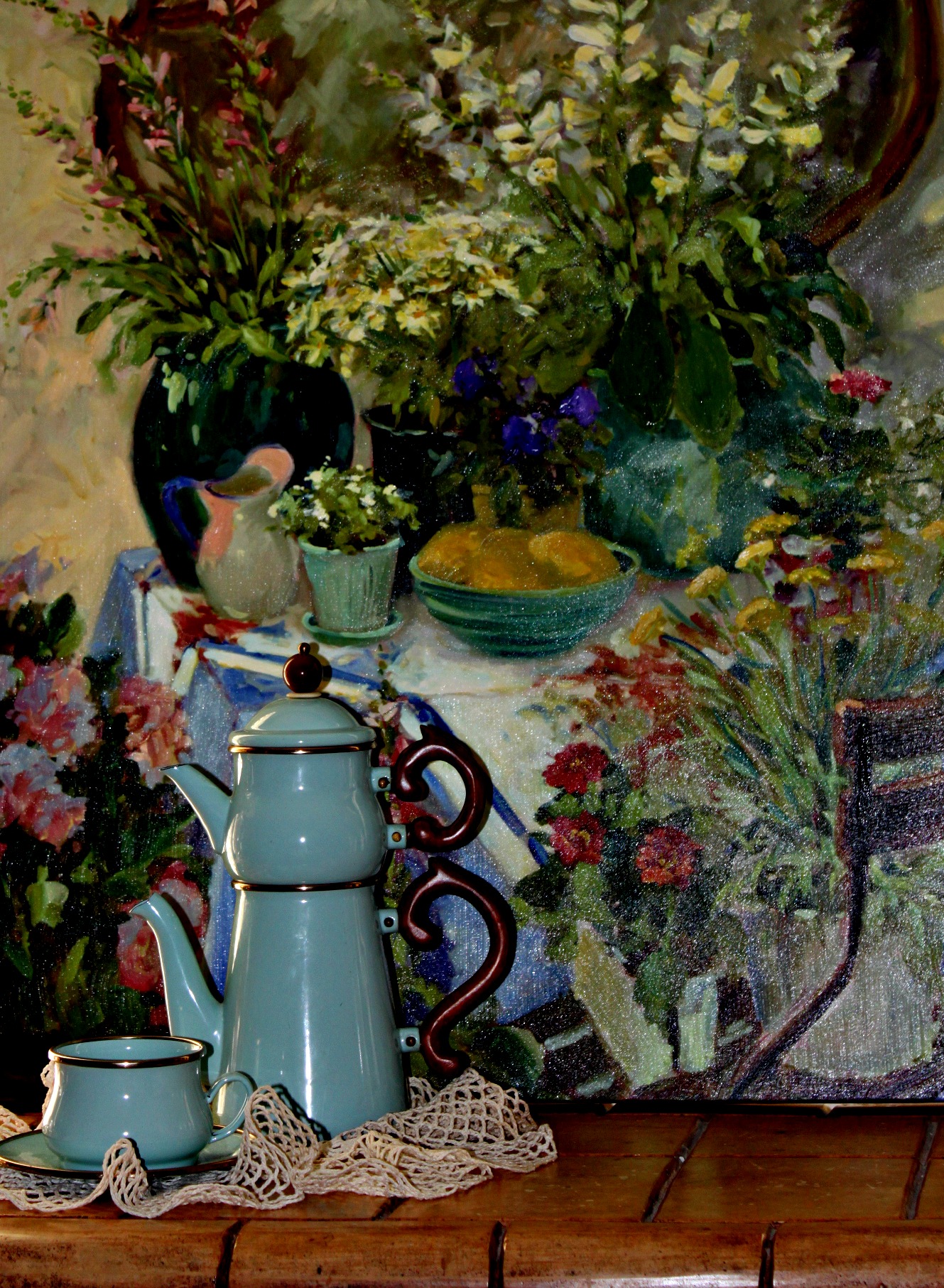 a painting of flowers sits on a shelf