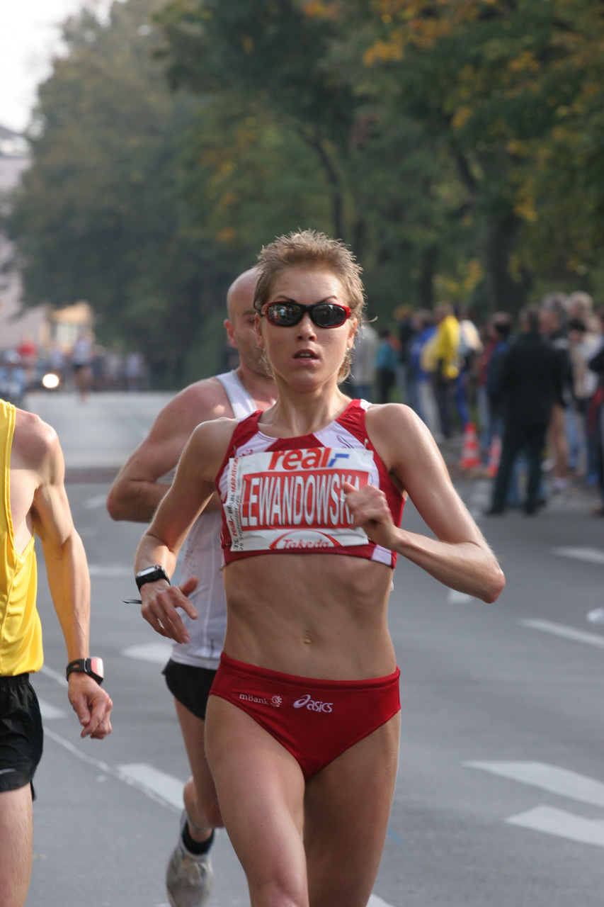 a man and woman jogging in an olympic triathlon race