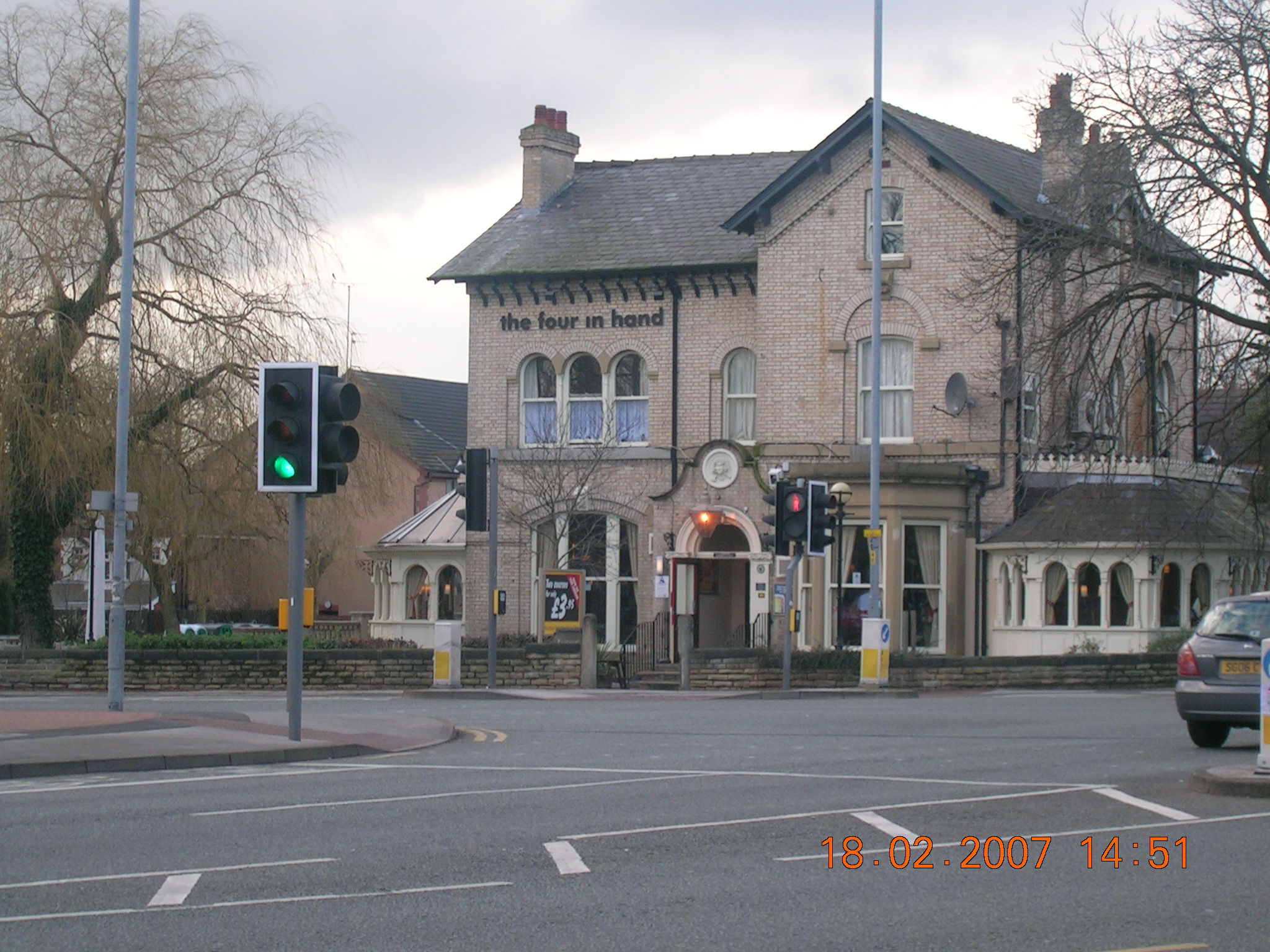 a large building sits next to a traffic light